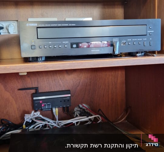 מערכת שמע עם כבלים ומכשירים טכניים בארון עץ
